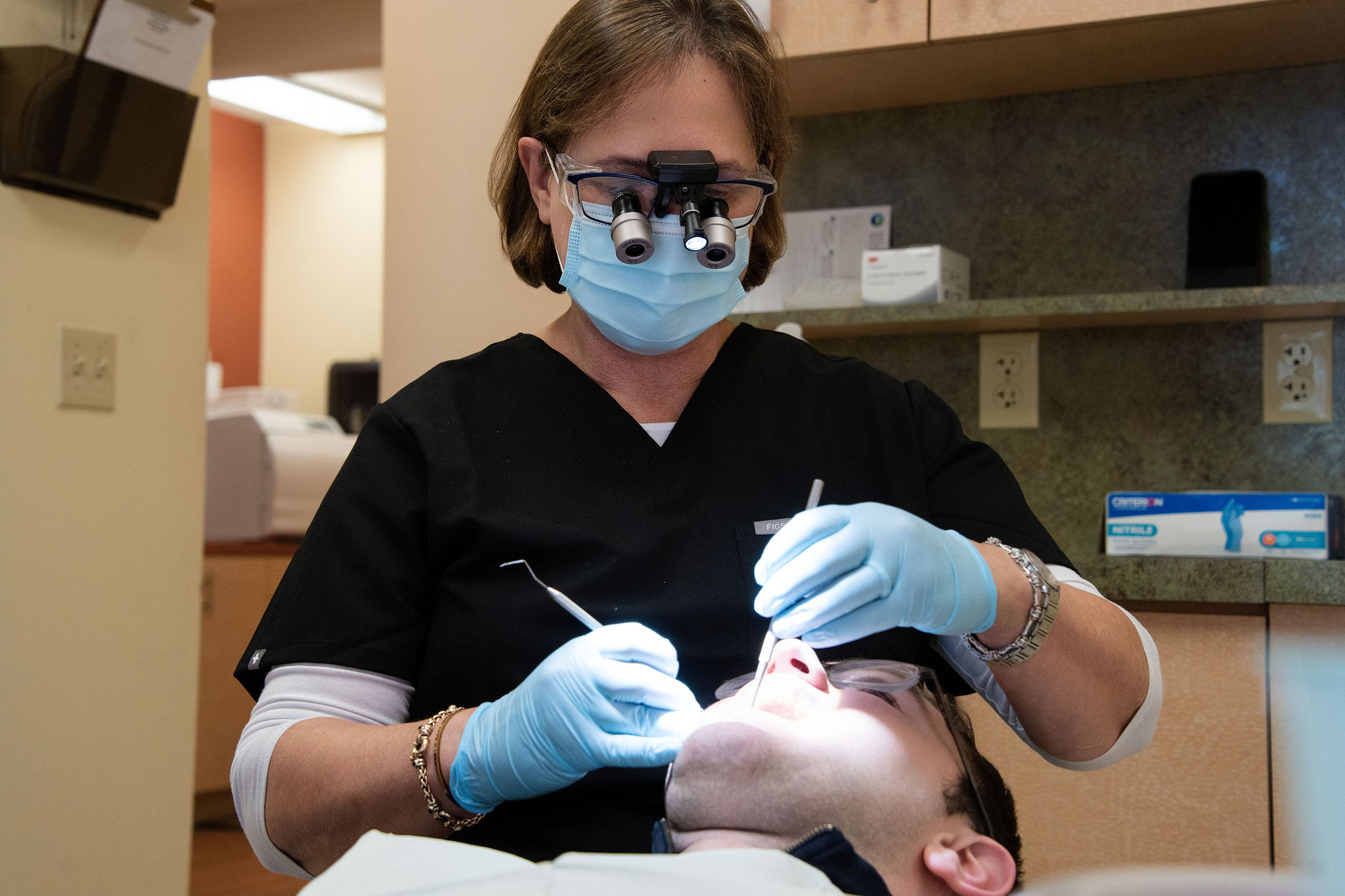 Dr. Riki Kreitman at work in her Highland Park dental office